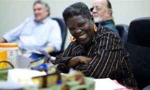 Lois Curtis sitting with her arms crossed and smiling toward the camera