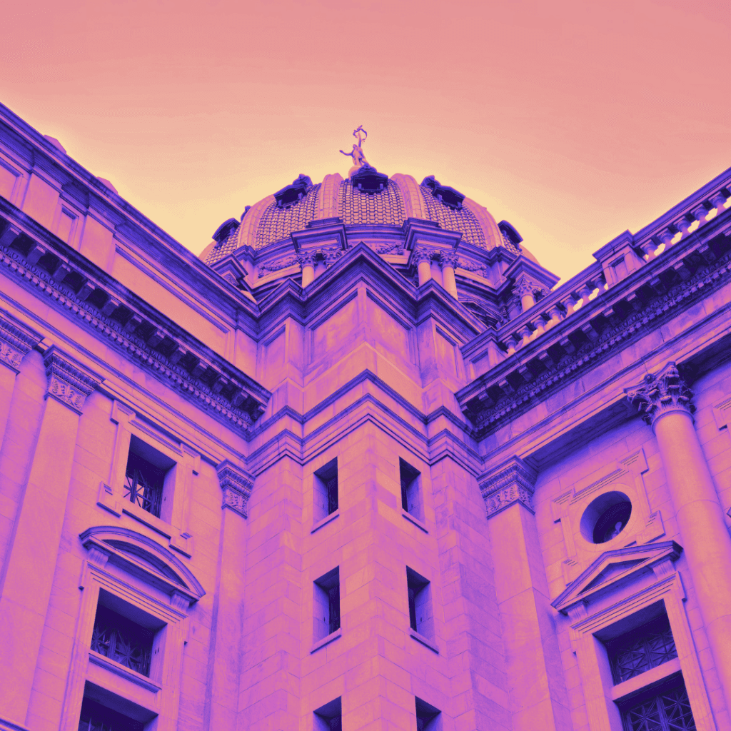 Picture of the PA State Capital dome from outside on the side of the building, color popped with pink and gold.