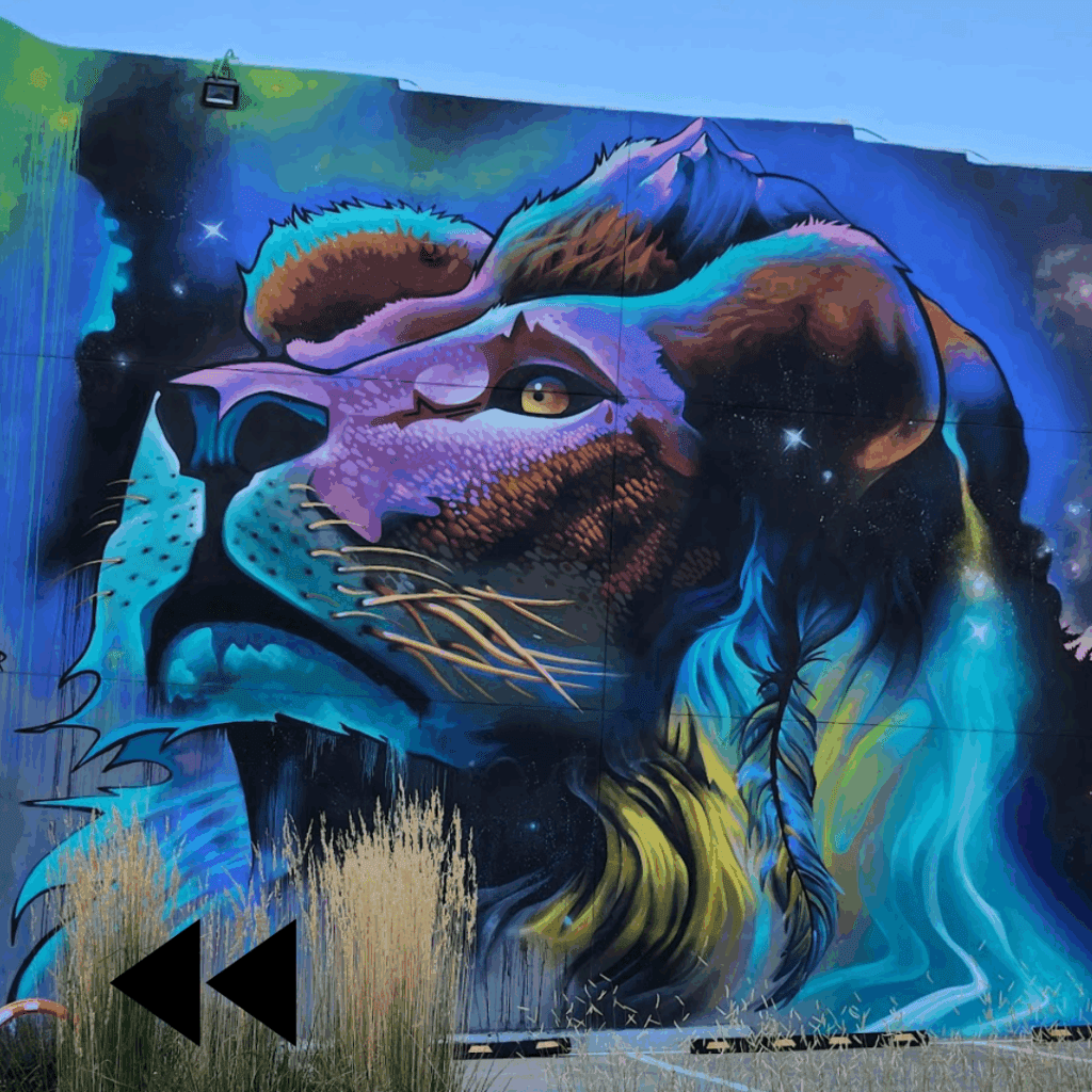 Colorful street art painting of a lion head